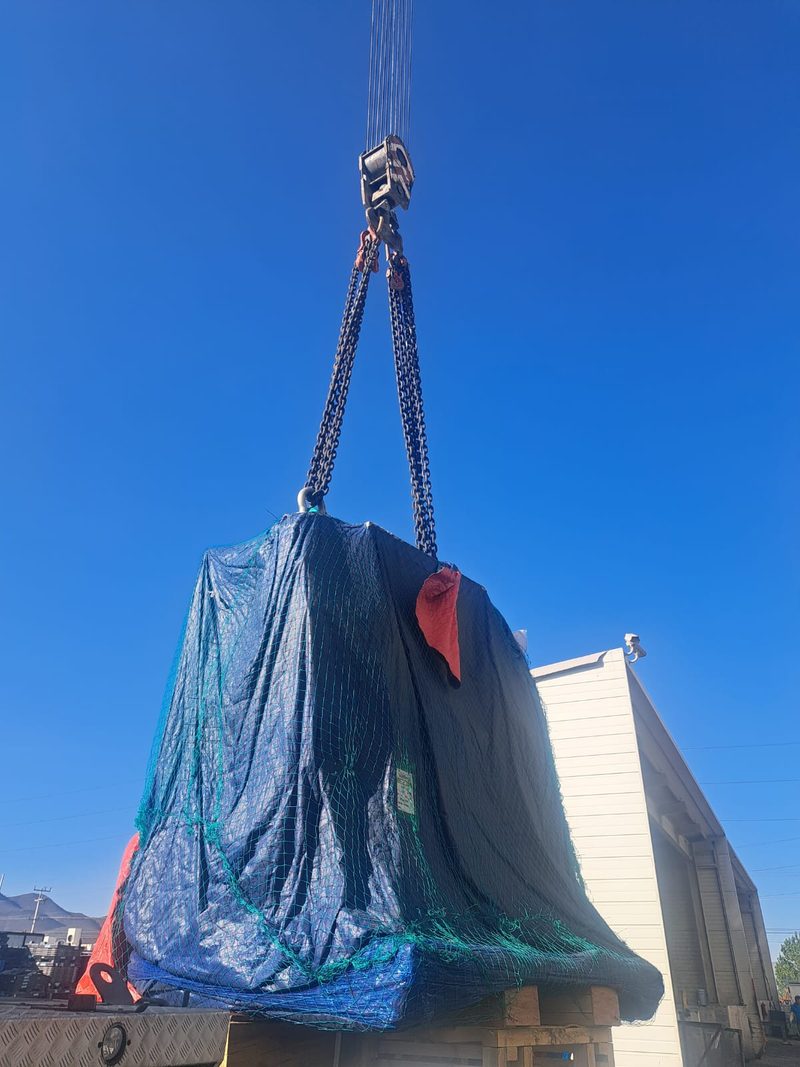 A wrapped package lifted for its move into the building.
