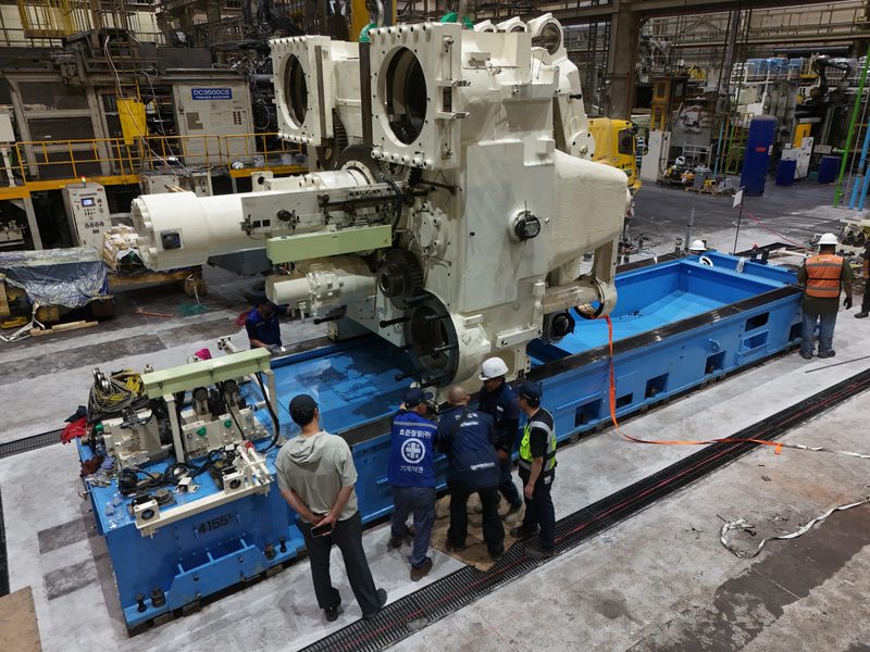 The machine standing on its bed as the crew step back.