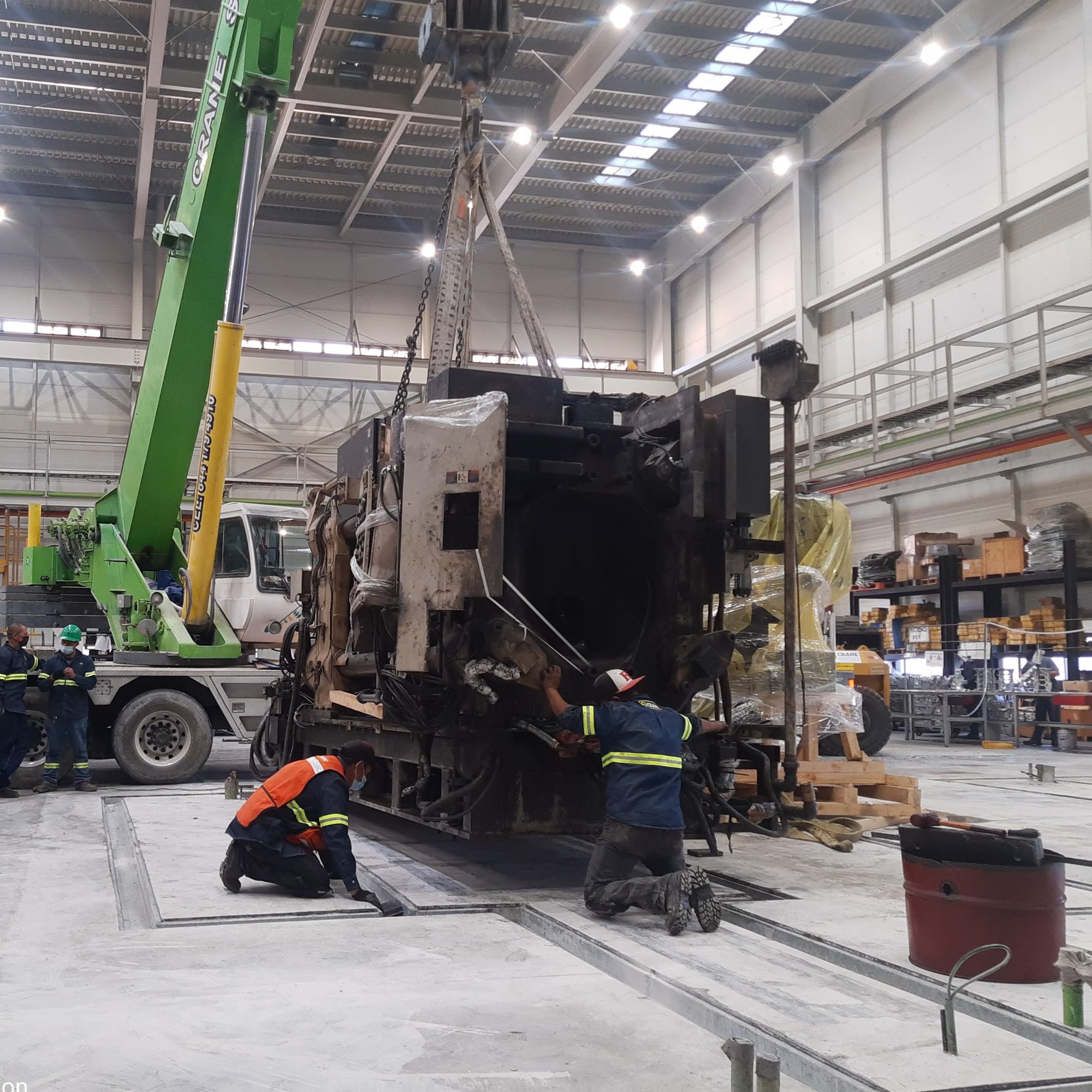 Machine lowered onto its foundation by crane.