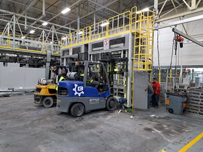 Uncrated equipment staged on the plant floor before setting.