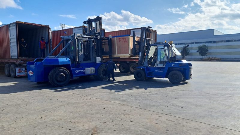 Long machine transported across the yard.